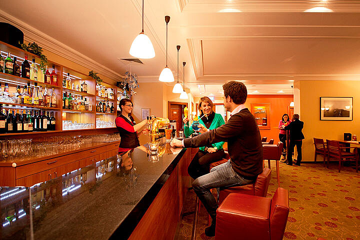 Couple enjoying drinks in Piano Bar