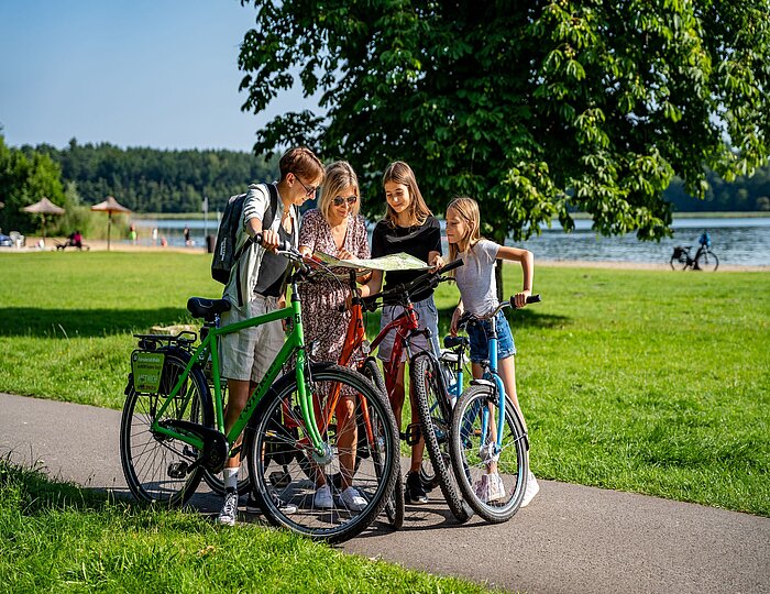 Familien fährt Rad am See